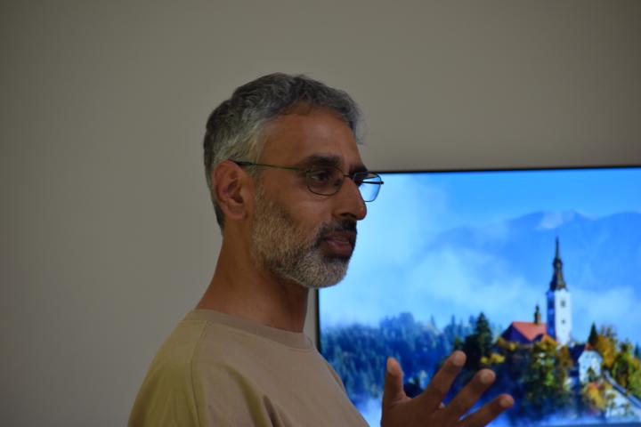 A person explaining something with both hands raised.